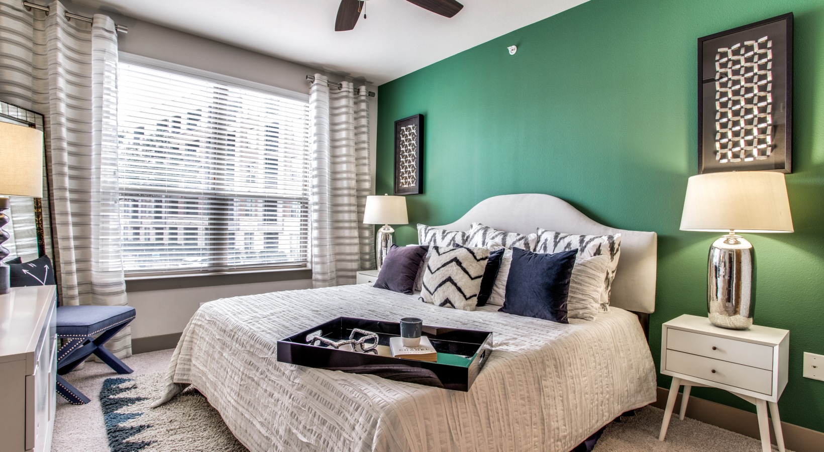 a bedroom with green walls and a white bed at The Live Oak at  Branch