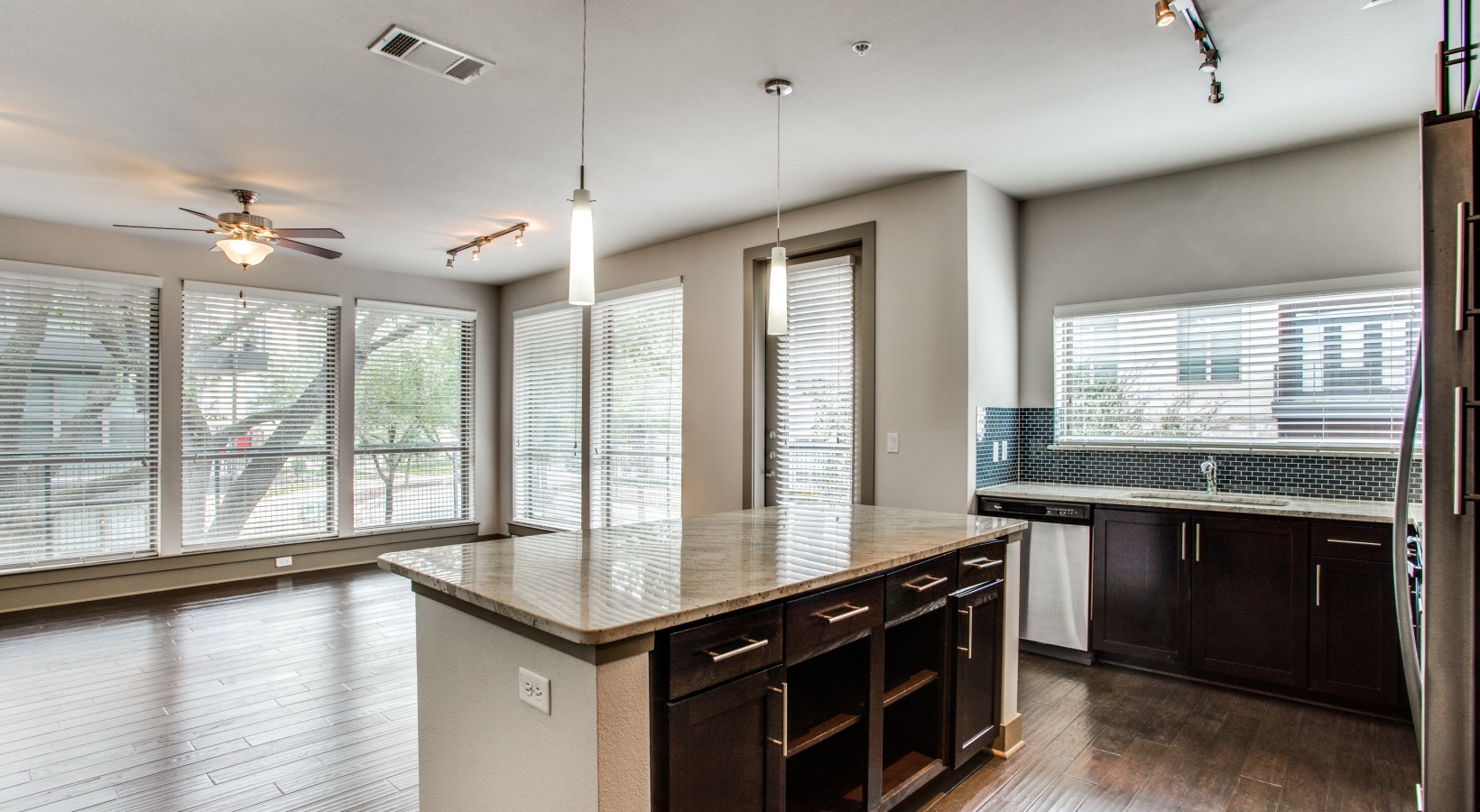 a large kitchen with hardwood floors and a large window at The Live Oak at  Branch