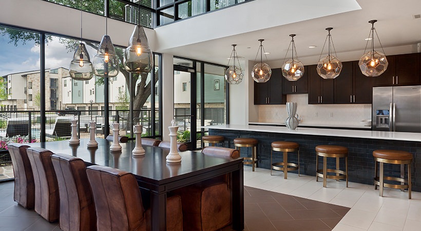 a modern kitchen with a large island and a large dining table at The Live Oak at  Branch