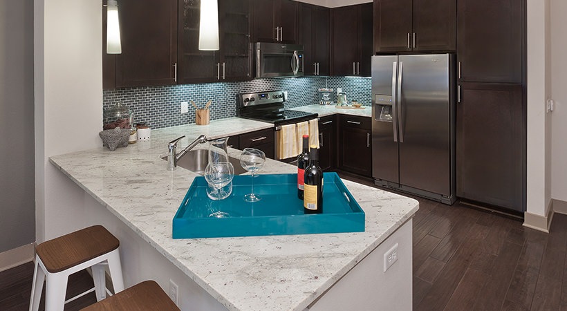a kitchen with a blue tray and a wine glass at The Live Oak at  Branch