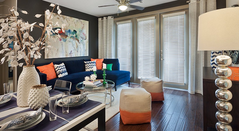 a living room with blue and orange accents and a couch at The Live Oak at  Branch